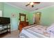 Well-lit main bedroom offering a wooden dresser with mirror, carpet, and access to an en-suite bathroom at 214 Verona Dr, Kissimmee, FL 34759