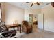 Comfortable office space with a leather recliner, desk, and adjacent room access through double doors at 214 Verona Dr, Kissimmee, FL 34759