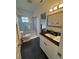 Bathroom with a glass-enclosed shower, modern fixtures, and sleek black tile flooring, providing a clean aesthetic at 2356 Chadwick Cir, Kissimmee, FL 34746
