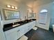 Modern bathroom with double vanity, sleek fixtures, granite countertops, and contemporary mirrors and lighting at 2356 Chadwick Cir, Kissimmee, FL 34746