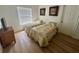 Bedroom featuring two twin beds, window with blinds, and artwork creating a cozy and inviting atmosphere at 2356 Chadwick Cir, Kissimmee, FL 34746