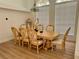 Elegant dining room boasts decorative chandelier, large windows and stylish wooden table with seating for eight at 2356 Chadwick Cir, Kissimmee, FL 34746