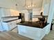 Modern kitchen with white cabinets, black countertops, and stainless steel appliances offers a sleek cooking space at 2356 Chadwick Cir, Kissimmee, FL 34746