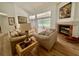 Bright living room features a fireplace and sliding glass doors leading to a screened-in pool at 2356 Chadwick Cir, Kissimmee, FL 34746
