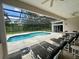 Inviting screened-in pool area with comfortable seating and lush greenery, perfect for outdoor relaxation at 2356 Chadwick Cir, Kissimmee, FL 34746