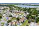 Aerial view of a residential neighborhood with single Gathering homes, green trees, and access to a nearby body of water at 2561 Montego Bay Blvd, Kissimmee, FL 34746