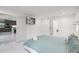 Bedroom with a view to the kitchen, showing minimalist design with television and ensuite access at 2561 Montego Bay Blvd, Kissimmee, FL 34746