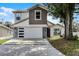 Charming two-story home featuring a clean two-car garage and modern stone accents at 2561 Montego Bay Blvd, Kissimmee, FL 34746
