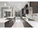 Modern kitchen featuring white countertops, stainless steel appliances, dark wood cabinets and marble backsplash at 2561 Montego Bay Blvd, Kissimmee, FL 34746