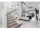 Bright, open living space featuring a cozy fireplace and modern staircase at 2561 Montego Bay Blvd, Kissimmee, FL 34746