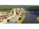 Aerial view of residential homes along a lake showcasing neighborhood, trees, and lawns at 2703 Eagle Canyon S Dr, Kissimmee, FL 34746