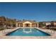 Inviting community pool with lounge chairs and a covered pavilion, perfect for relaxation and social gatherings at 2703 Eagle Canyon S Dr, Kissimmee, FL 34746