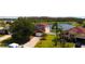 Beautiful two-story home with a brick driveway, well-manicured lawn, and palm trees, set against a serene lake backdrop at 2703 Eagle Canyon S Dr, Kissimmee, FL 34746