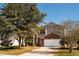 Charming two-story home with a brick facade and a well-manicured front yard and beautiful, mature trees at 2703 Eagle Canyon S Dr, Kissimmee, FL 34746