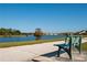Relaxing view of the lake from a nearby bench, perfect for enjoying the peaceful surroundings and nature at 2703 Eagle Canyon S Dr, Kissimmee, FL 34746