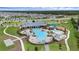 Aerial view of community pool and playground areas near a community center and a residential neighborhood at 2838 Common Crane Ct, Harmony, FL 34773