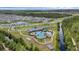 This aerial image features a community pool, playground, and common areas with lush landscaping at 2838 Common Crane Ct, Harmony, FL 34773