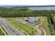 This image shows the community pool, surrounding wooded areas, and neighborhood at 2838 Common Crane Ct, Harmony, FL 34773