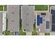 A top-down perspective of neighboring homes featuring solar panels and manicured yards at 2838 Common Crane Ct, Harmony, FL 34773