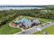 An aerial shot shows a community pool, playground, walking paths, and the clubhouse, all surrounded by trees at 2838 Common Crane Ct, Harmony, FL 34773