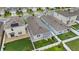 Aerial view of a two-story home boasting solar panels, complemented by a fenced yard and an outdoor cooking space at 2838 Common Crane Ct, Harmony, FL 34773