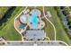Overhead aerial view of a pool, playground, and community center nestled in natural surroundings at 2838 Common Crane Ct, Harmony, FL 34773