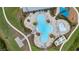 Aerial view showing a clover-shaped swimming pool with a splash pad and lounge seating at 2838 Common Crane Ct, Harmony, FL 34773