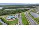 An aerial view showcases a neighborhood pool and splash pad with surrounding residential homes at 2838 Common Crane Ct, Harmony, FL 34773