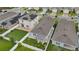 An aerial view of a two-story home featuring solar panels and a fenced yard with an outdoor kitchen space at 2838 Common Crane Ct, Harmony, FL 34773