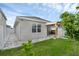 Well-manicured backyard with a covered lanai, showcasing the property's outdoor living space at 2838 Common Crane Ct, Harmony, FL 34773
