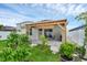 Lush backyard featuring green lawn, a covered lanai, and well-maintained landscaping at 2838 Common Crane Ct, Harmony, FL 34773