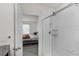 Bathroom featuring a shower with clear glass door and the bedroom in the background at 2838 Common Crane Ct, Harmony, FL 34773