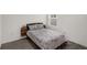 Simple yet comfortable bedroom with neutral tones, wood-look tile floors, and a window for natural light at 2838 Common Crane Ct, Harmony, FL 34773