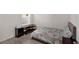 Cozy bedroom with wood-look tile flooring and a comfortable bed at 2838 Common Crane Ct, Harmony, FL 34773