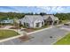 Community center exterior with ample parking, pool, and playground areas in a lush, landscaped setting at 2838 Common Crane Ct, Harmony, FL 34773