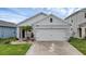 Charming single-Gathering home featuring a neutral color scheme, two-car garage, and landscaped yard at 2838 Common Crane Ct, Harmony, FL 34773