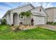 Welcoming single-story home with landscaped front yard and two-car garage at 2838 Common Crane Ct, Harmony, FL 34773