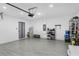 Garage with hard wood flooring, multiple overhead lights, and various storage solutions at 2838 Common Crane Ct, Harmony, FL 34773