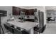 This is a Kitchen with a breakfast bar, stainless steel appliances, stylish backsplash, and dark wood cabinets at 2838 Common Crane Ct, Harmony, FL 34773