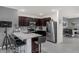 Modern kitchen featuring granite countertops, stainless steel appliances, and dark wood cabinets at 2838 Common Crane Ct, Harmony, FL 34773