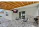 Outdoor lanai featuring hardscape flooring, two lounge chairs, and an outdoor grill at 2838 Common Crane Ct, Harmony, FL 34773
