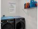 Functional laundry room featuring modern washer and dryer units, storage shelf, and a window for natural light at 2838 Common Crane Ct, Harmony, FL 34773