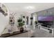 Bright and airy living room featuring modern decor, large TV, and sliding glass doors to the backyard at 2838 Common Crane Ct, Harmony, FL 34773