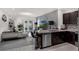 Open-concept design showcasing living room and kitchen with granite countertops, stainless steel appliances, and tile floors at 2838 Common Crane Ct, Harmony, FL 34773