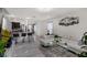 This open-concept living room features modern decor, tile flooring, and seamless flow into the kitchen area at 2838 Common Crane Ct, Harmony, FL 34773