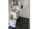 Bathroom features include black tile flooring, white sink and cabinets, and a toilet at 2900 S Semoran Blvd # 1, Orlando, FL 32822