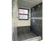 Modern bathroom featuring a tiled walk-in shower, window and neutral finishes at 2900 S Semoran Blvd # 1, Orlando, FL 32822