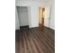 Bedroom featuring closet and rich dark wood-look laminate flooring at 2900 S Semoran Blvd # 1, Orlando, FL 32822