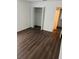 Bedroom featuring wood floors, a closet with folding doors, and neutral tones at 2900 S Semoran Blvd # 1, Orlando, FL 32822