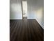 Bedroom with new dark wood-look flooring and access to a bathroom at 2900 S Semoran Blvd # 1, Orlando, FL 32822